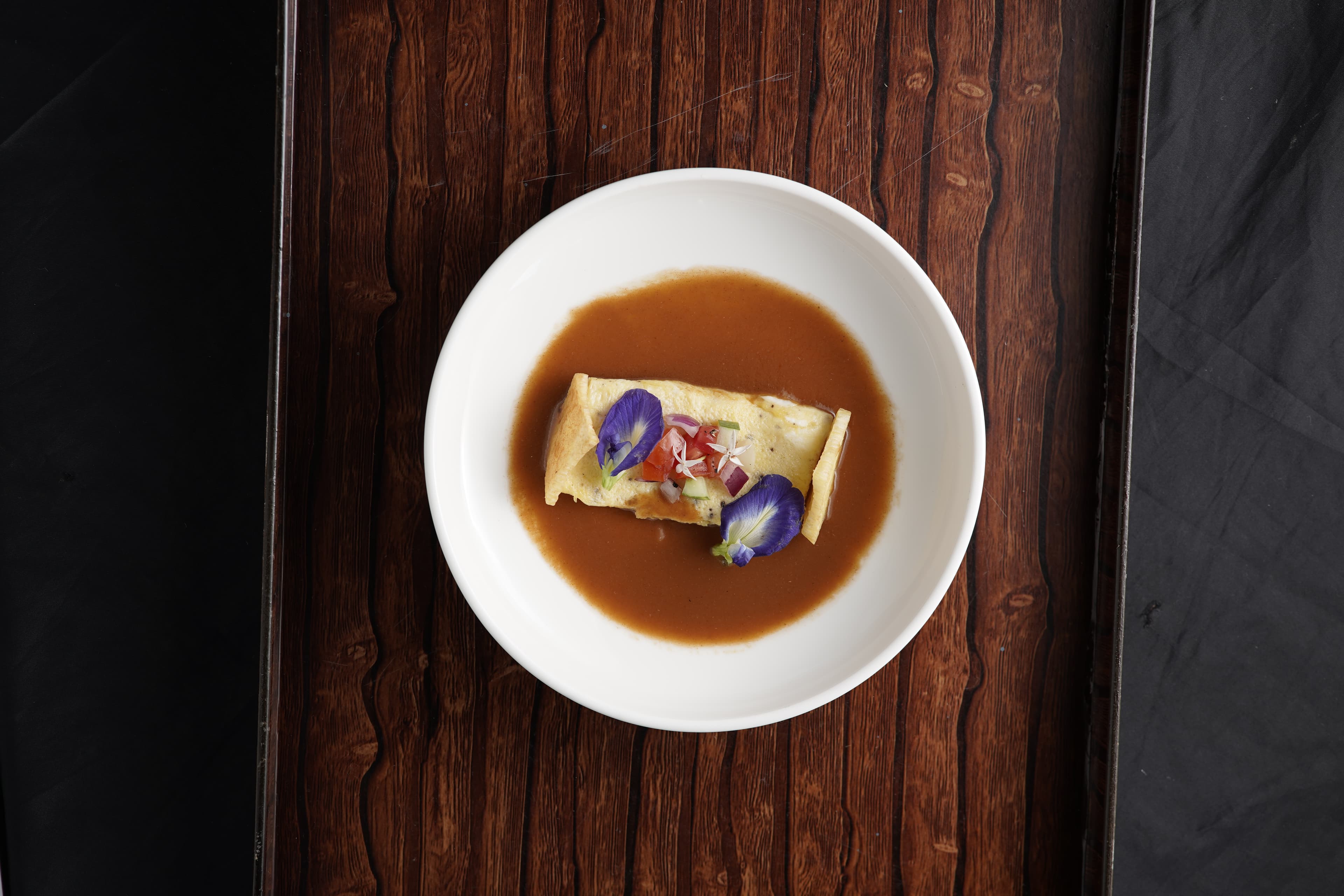 STARTER: Mgbe (oyster) omelette and thinly fried yam resting in a prawn head bisque