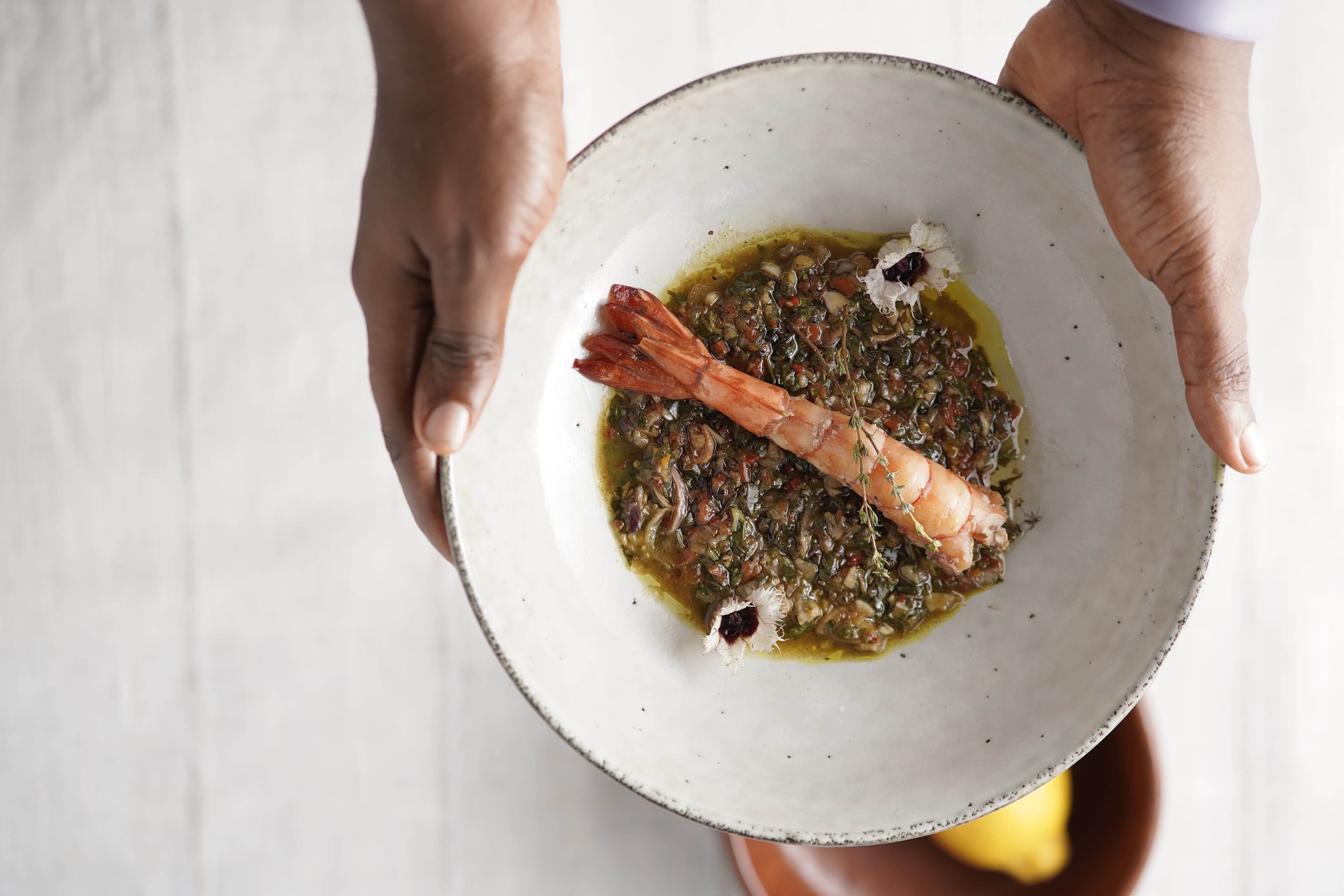 THIRD STORY: Pan-fried epolï (tiger prawns) tossed in scent-leaf chimichurri